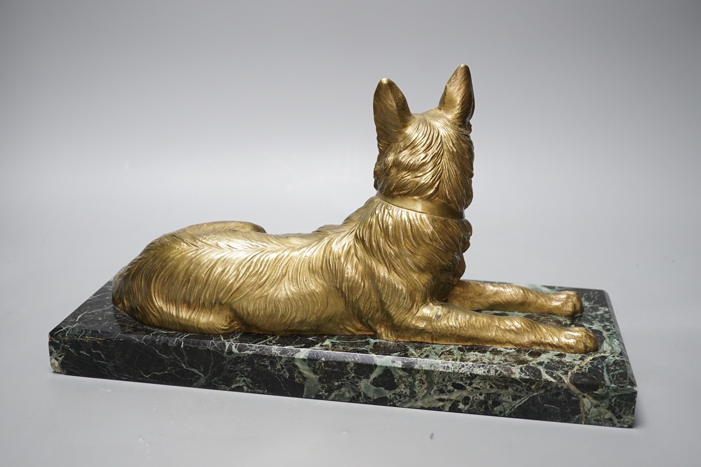After D H Chiparus, a gilt metal figure of a German Shepherd dog, on marble base, 36 cms wide